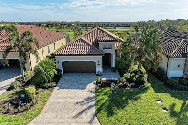 view of front of home with a garage and a front yard