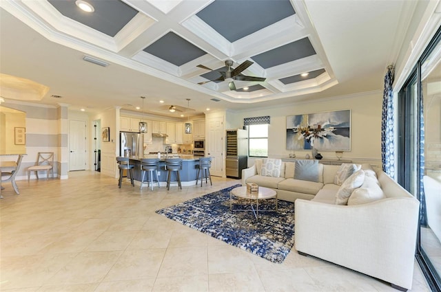 tiled living room with crown molding, beamed ceiling, ceiling fan, and coffered ceiling