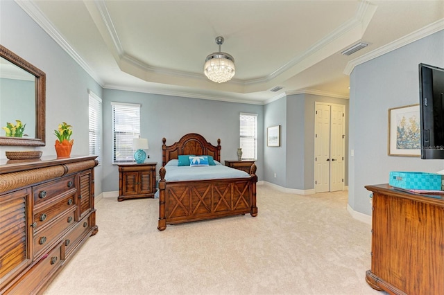 carpeted bedroom with a raised ceiling and ornamental molding