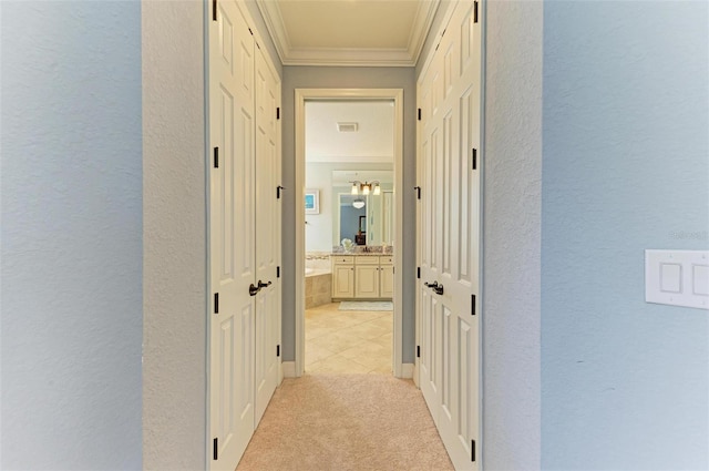 hall featuring light colored carpet and crown molding