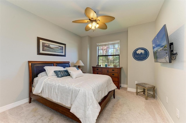 bedroom featuring light carpet and ceiling fan