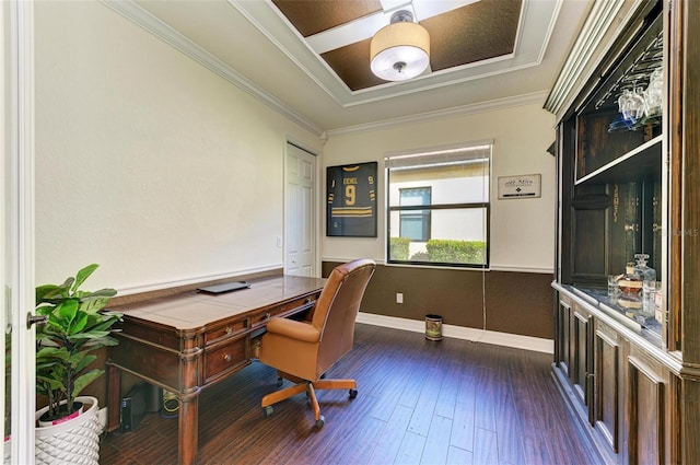 office with built in desk, dark hardwood / wood-style floors, and ornamental molding