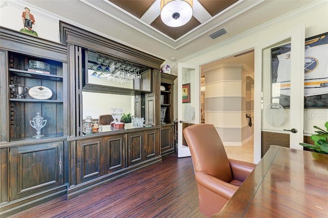 office with crown molding, built in features, and dark wood-type flooring