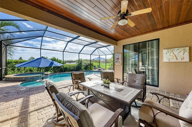 view of patio with glass enclosure and a pool with hot tub