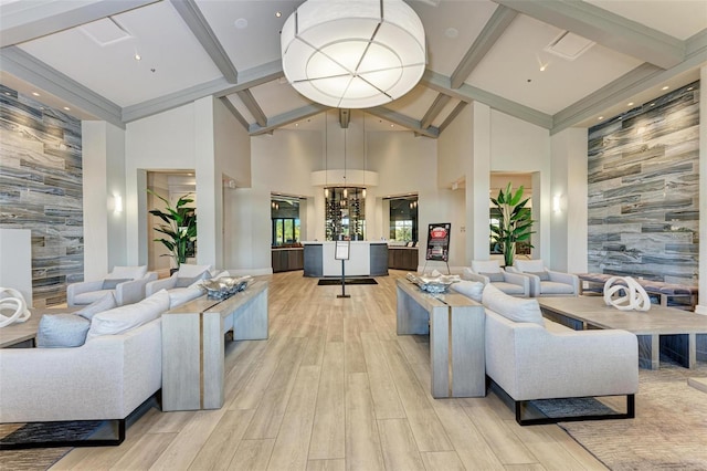 living room with beamed ceiling, light hardwood / wood-style floors, and high vaulted ceiling