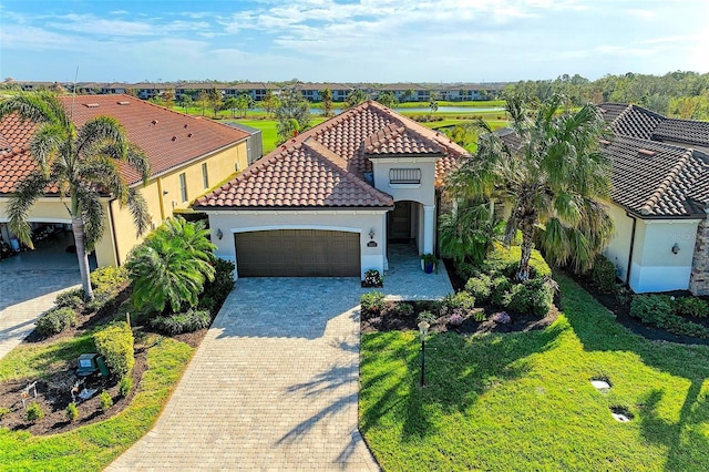 view of front facade with decorative driveway, stucco siding, a garage, a tiled roof, and a front lawn