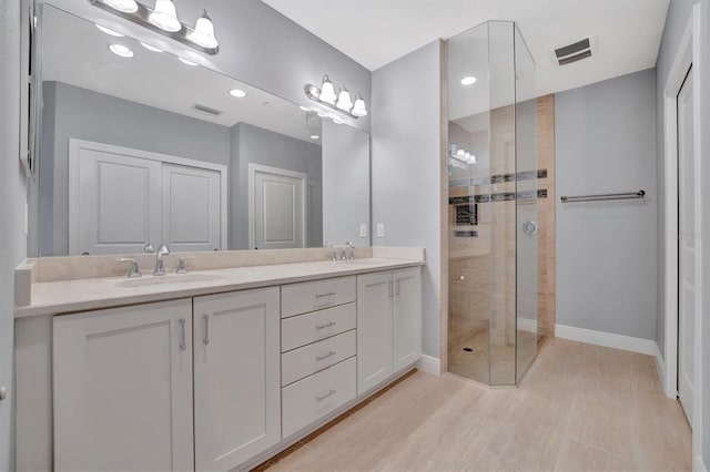 bathroom featuring vanity and a shower with shower door