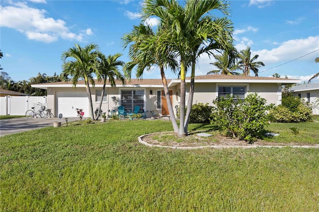 ranch-style home with a garage and a front lawn