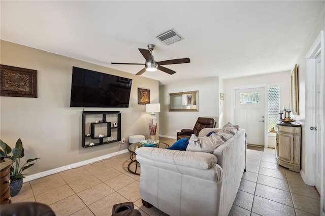 tiled living room featuring ceiling fan