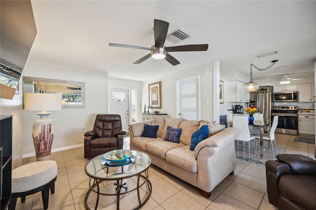 tiled living room with ceiling fan