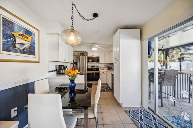 tiled dining space with ceiling fan