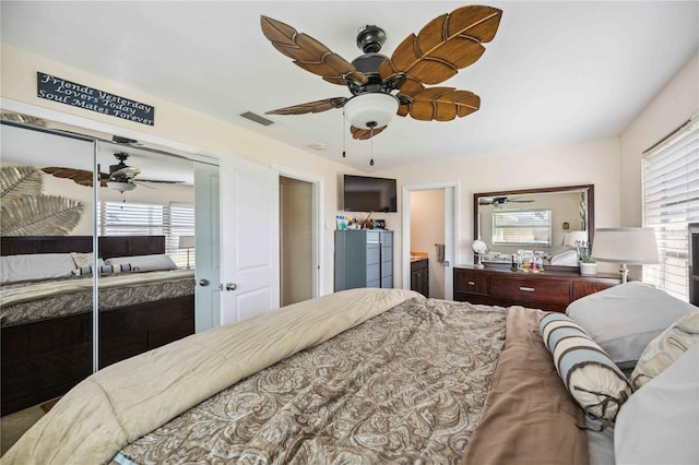 bedroom featuring a closet, ceiling fan, and ensuite bathroom