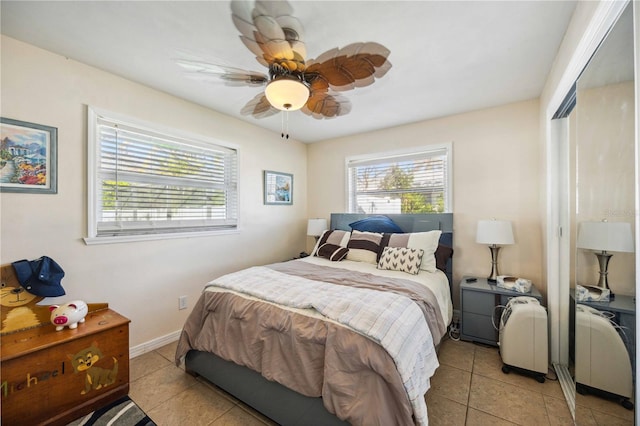 bedroom featuring light tile patterned flooring and ceiling fan