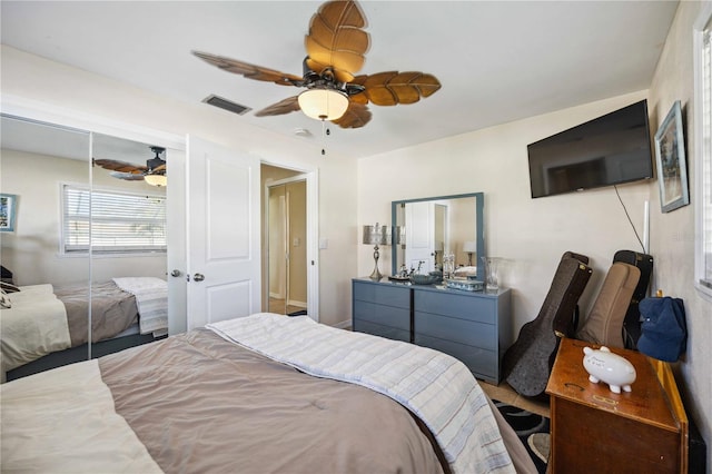 bedroom with ceiling fan and a closet