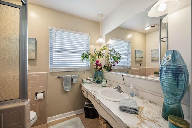 bathroom featuring toilet, vanity, and tile patterned flooring