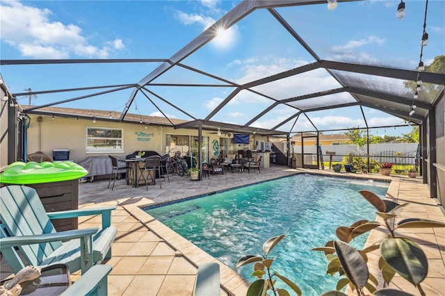 view of swimming pool featuring a lanai and a patio