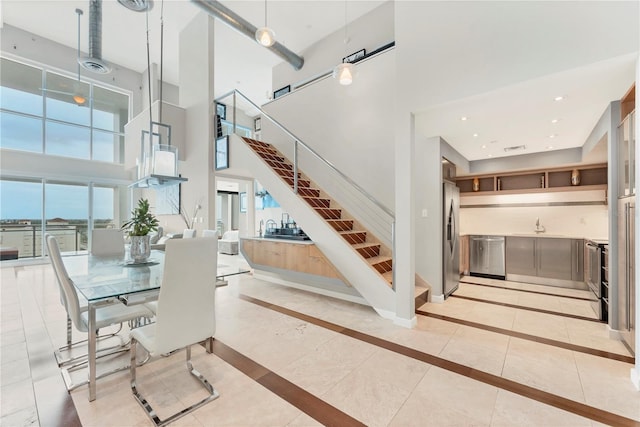 1990 Main St Unit 15, Sarasota, FL 34236 - dining space with a towering ceiling, plenty of natural light, inlaid floor details, stairway, and baseboards