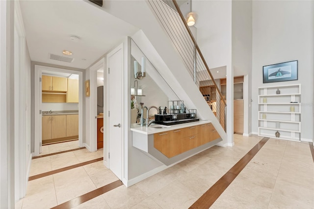 1990 Main St Unit 15, Sarasota, FL 34236 - foyer entrance with stairs, baseboards, light tile patterned floors, a towering ceiling, and inlaid floor details