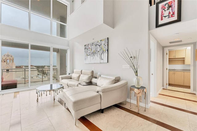 tiled living room with a towering ceiling