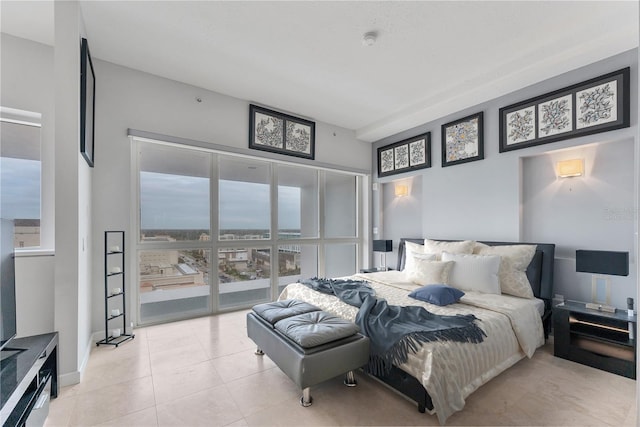 bedroom with access to outside and light tile patterned floors