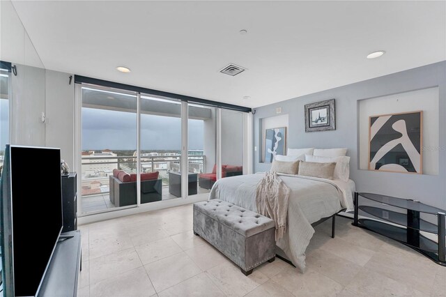 1990 Main St Unit 15, Sarasota, FL 34236 - bedroom with expansive windows, access to exterior, fridge, and light tile patterned floors