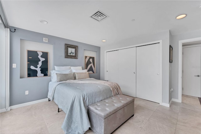 bedroom featuring a closet and light tile patterned floors