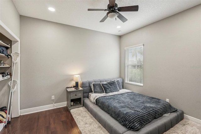 bedroom featuring ceiling fan and dark wood-type flooring