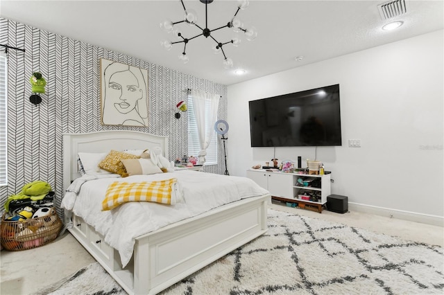 carpeted bedroom with a notable chandelier