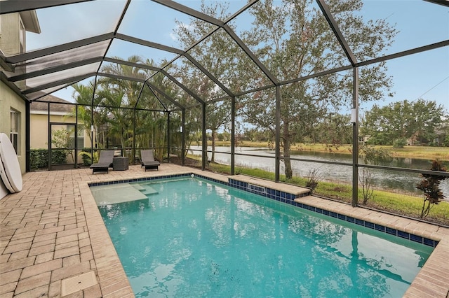 view of swimming pool with glass enclosure, a water view, and a patio