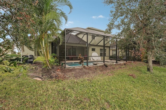 back of property featuring glass enclosure and a lawn