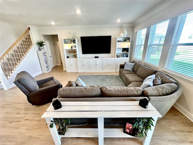 living room featuring light hardwood / wood-style floors and ornamental molding