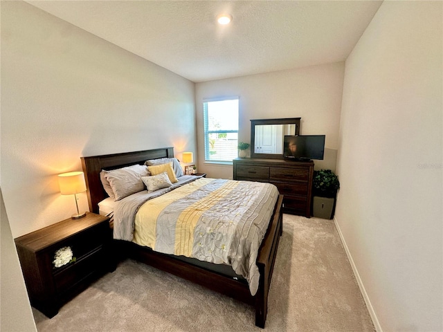 bedroom with light colored carpet