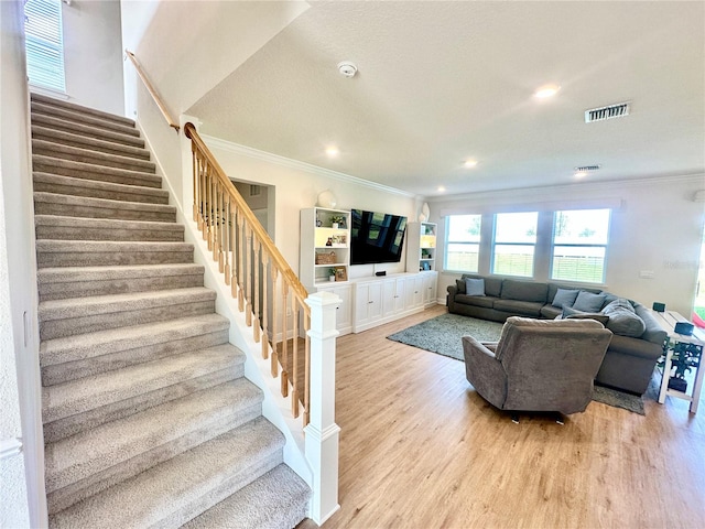 living room with light hardwood / wood-style flooring and ornamental molding