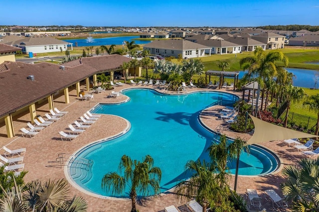 view of swimming pool featuring a pergola, a patio area, and a water view