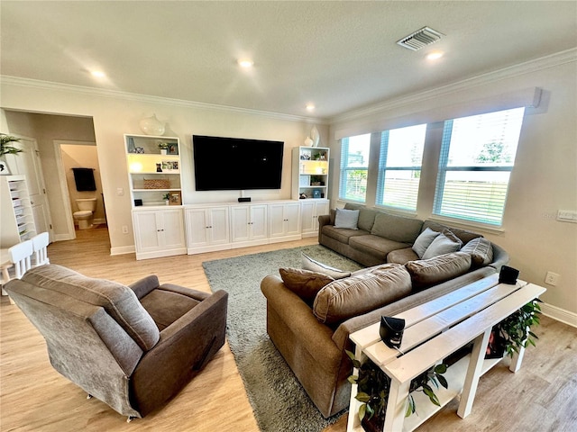 living room with crown molding and light wood-type flooring