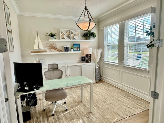 office space featuring ornamental molding, a textured ceiling, and light wood-type flooring