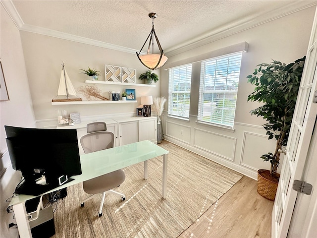 office space featuring crown molding, light hardwood / wood-style flooring, and a textured ceiling