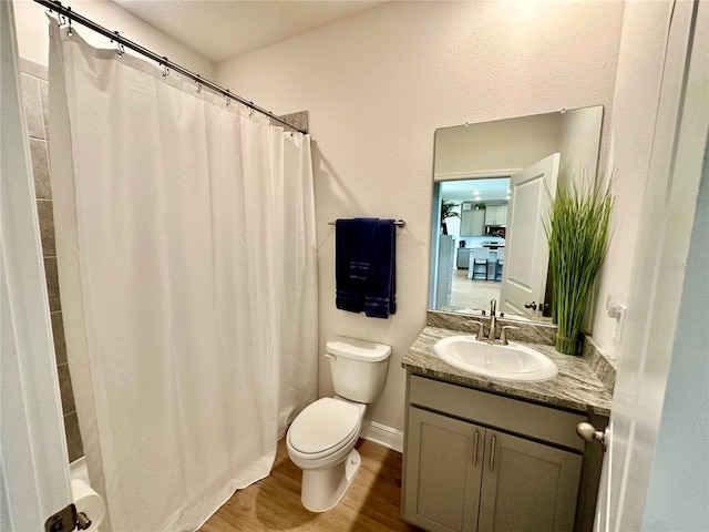 bathroom with vanity, toilet, and wood-type flooring