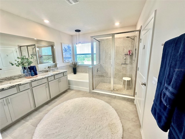 bathroom featuring tile patterned floors, vanity, a textured ceiling, and shower with separate bathtub