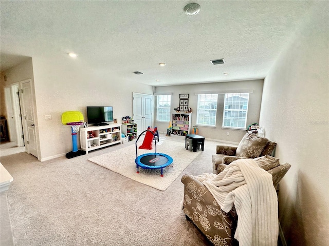 game room featuring carpet flooring and a textured ceiling