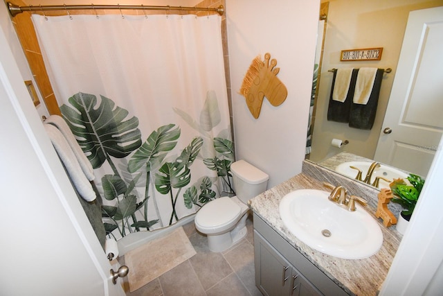 bathroom with tile patterned floors, vanity, toilet, and walk in shower