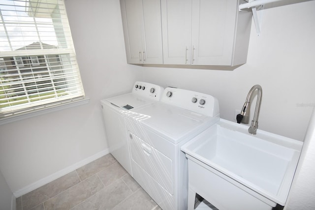 clothes washing area with cabinets, independent washer and dryer, sink, and light tile patterned floors