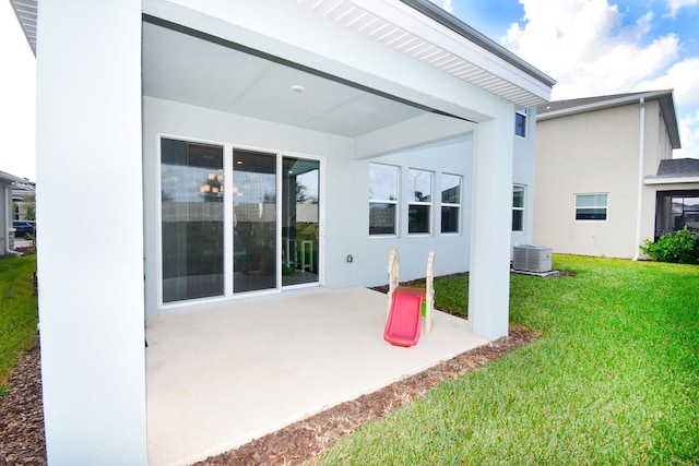 rear view of house with a lawn and a patio