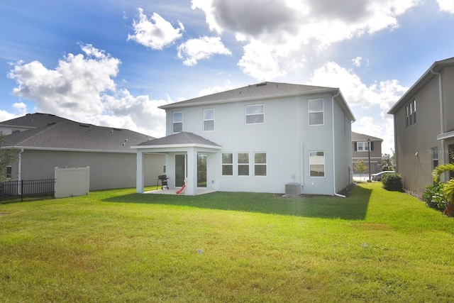 back of property featuring a lawn, a patio area, and cooling unit