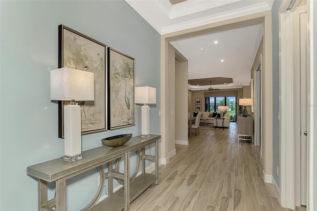 hall featuring light wood-type flooring and ornamental molding