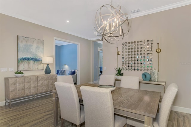 dining room featuring an inviting chandelier, dark hardwood / wood-style flooring, and ornamental molding