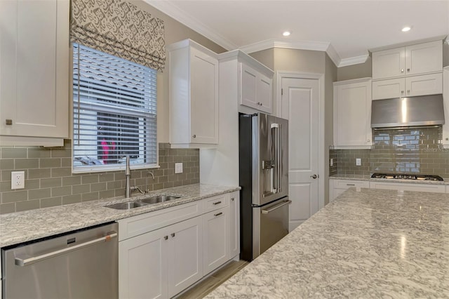 kitchen with crown molding, appliances with stainless steel finishes, decorative backsplash, sink, and white cabinets