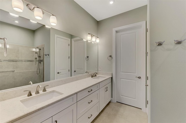 bathroom with vanity, tile patterned floors, and a tile shower