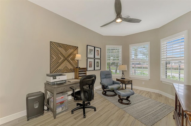 office space with light wood-type flooring, plenty of natural light, and ceiling fan