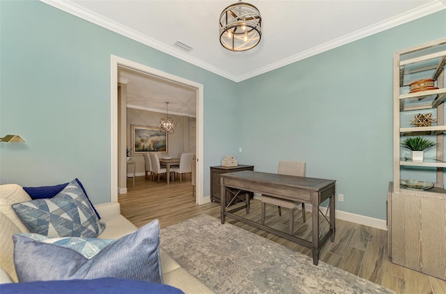 office area featuring light wood-type flooring, a chandelier, and crown molding